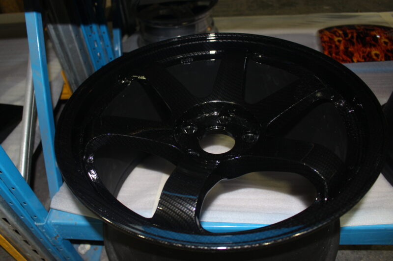 Car alloy wheels coated in carbon fibre