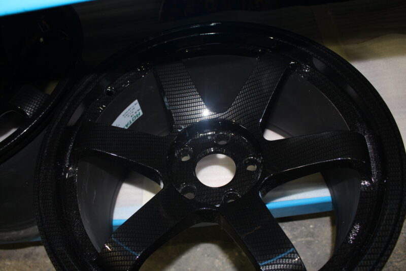 Car alloy wheels coated in carbon fibre