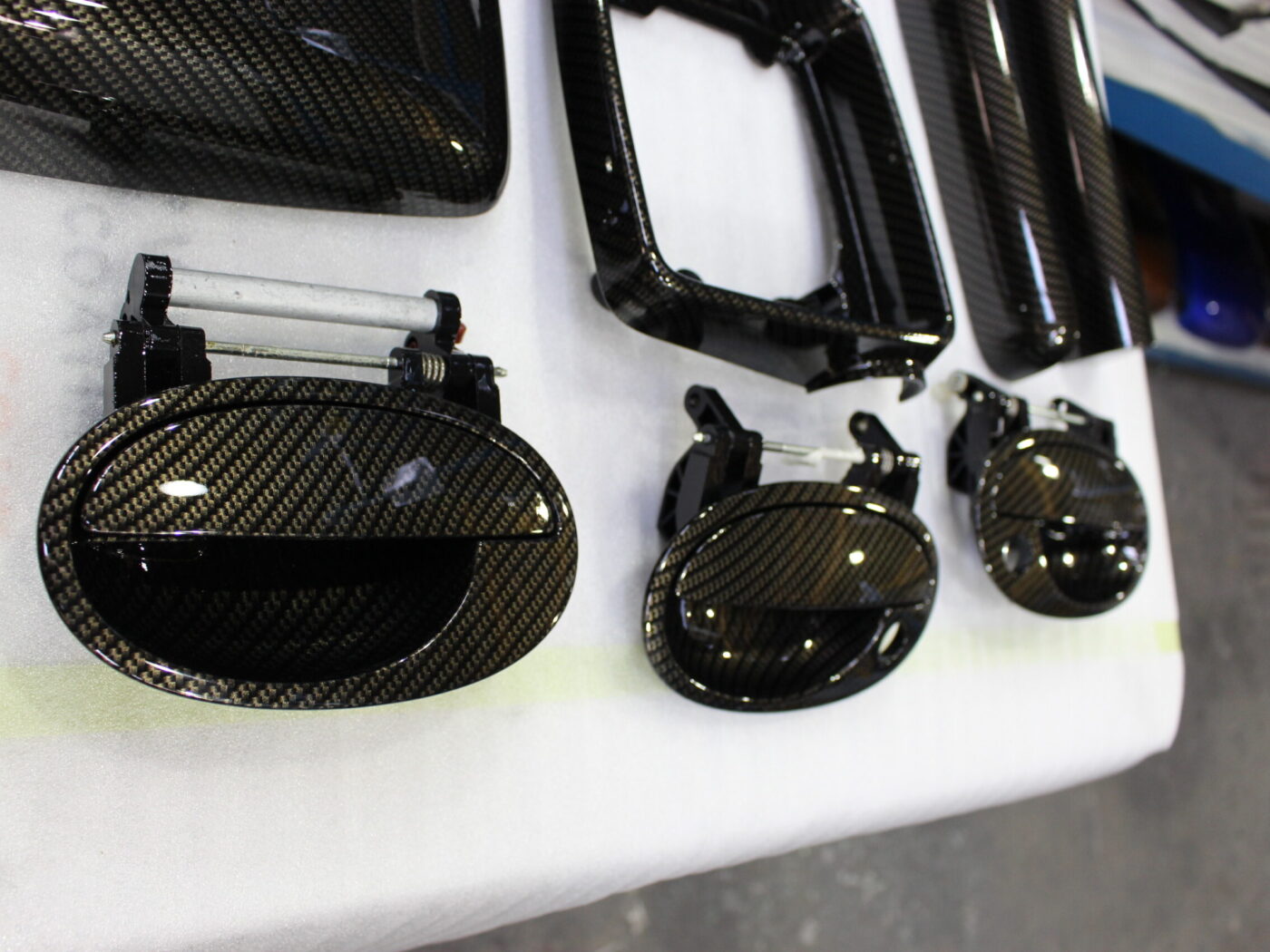 Various car interior parts coated in carbon fibre