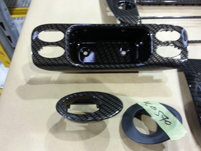 Car interior part coated in carbon fibre hydrographic film painted black