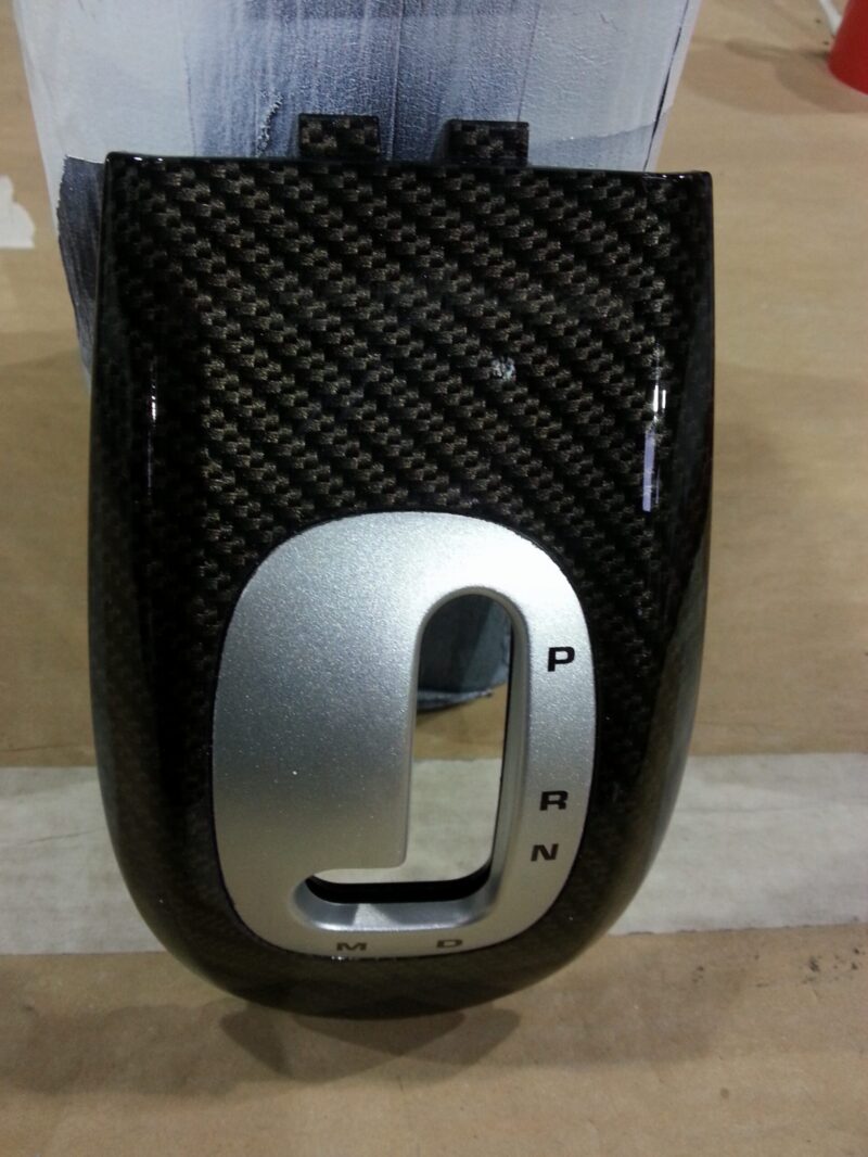 Car interior part coated in carbon fibre hydrographic film painted black