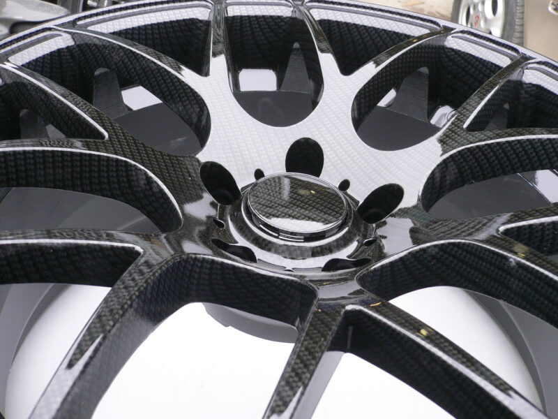 Car alloy wheels coated in carbon fibre