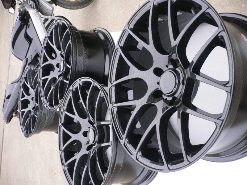 Car alloy wheels coated in carbon fibre