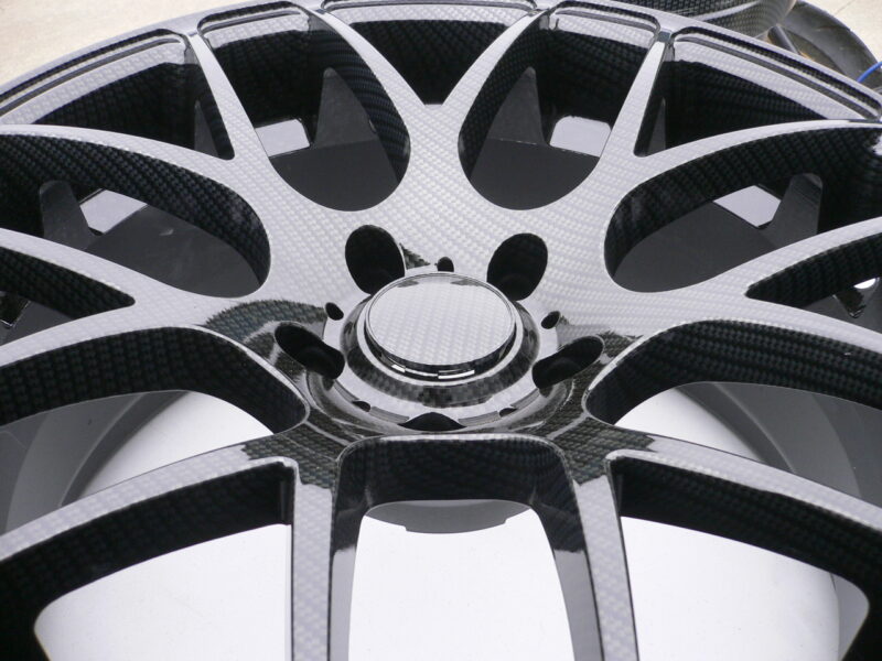 Car alloy wheels coated in carbon fibre