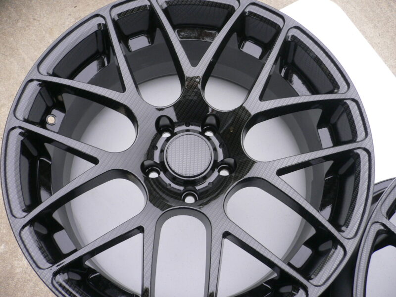 Car alloy wheels coated in carbon fibre