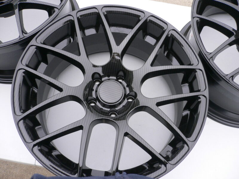 Car alloy wheels coated in carbon fibre