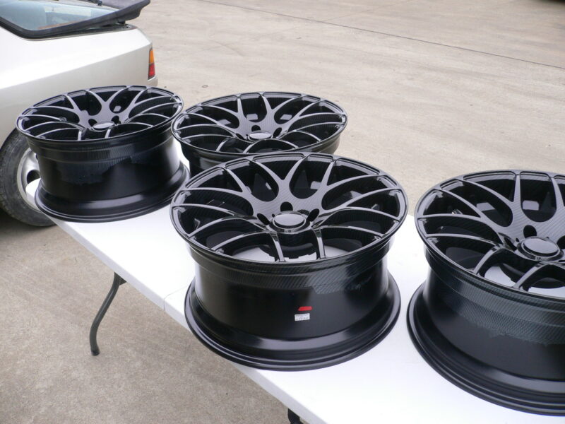 Car alloy wheels coated in carbon fibre