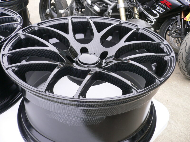 Car alloy wheels coated in carbon fibre