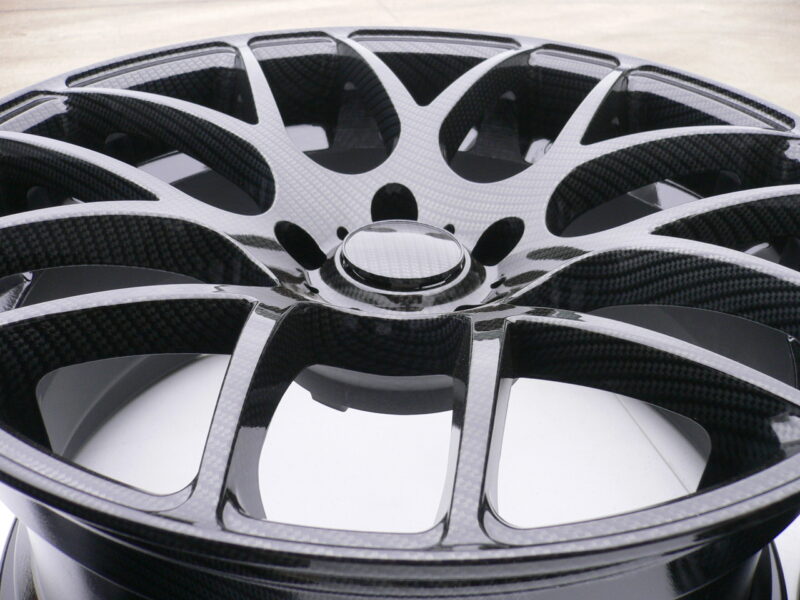 Car alloy wheels coated in carbon fibre