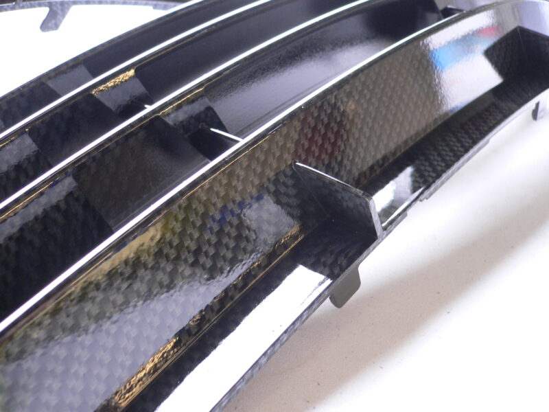 Car radiator cover coated in carbon fibre hydrographic film painted black
