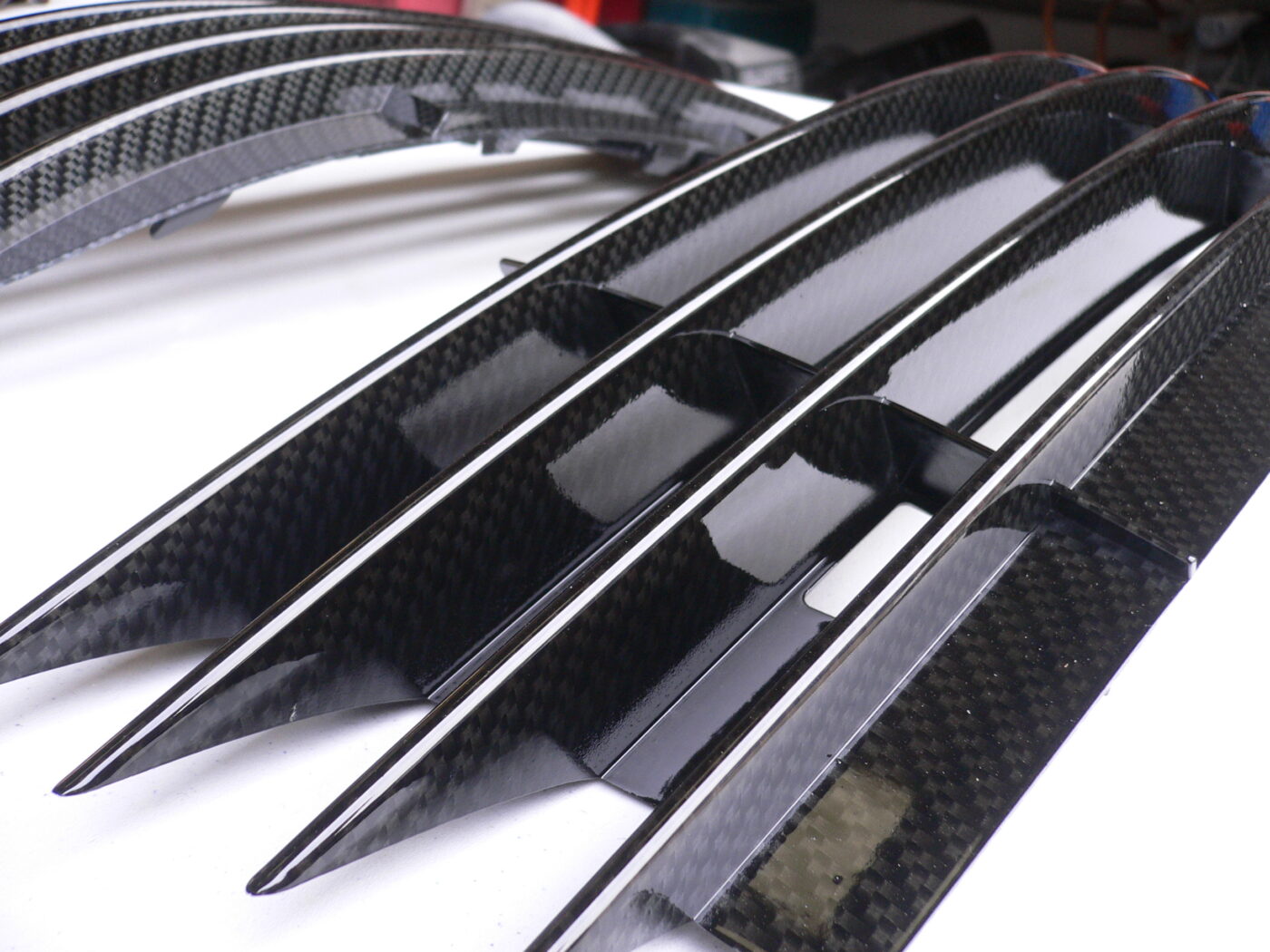 Car radiator cover coated in carbon fibre hydrographic film painted black