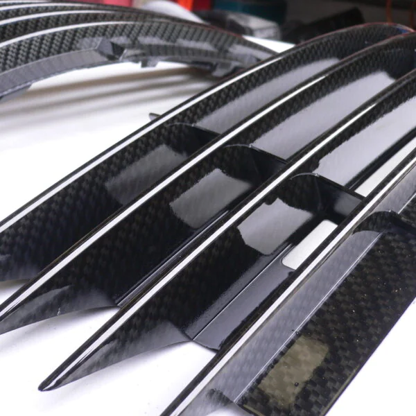 Car radiator cover coated in carbon fibre hydrographic film painted black