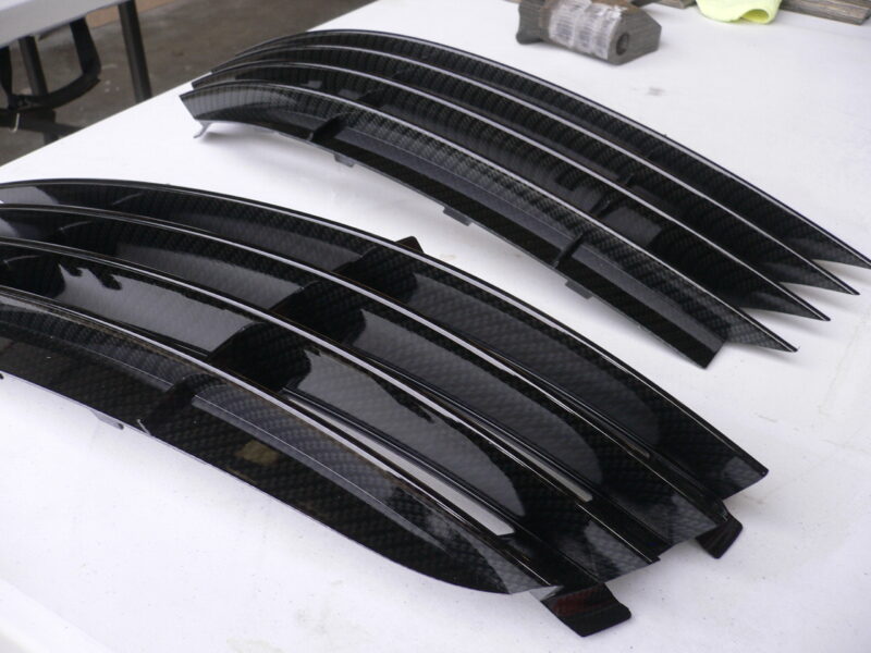 Car radiator cover coated in carbon fibre hydrographic film painted black