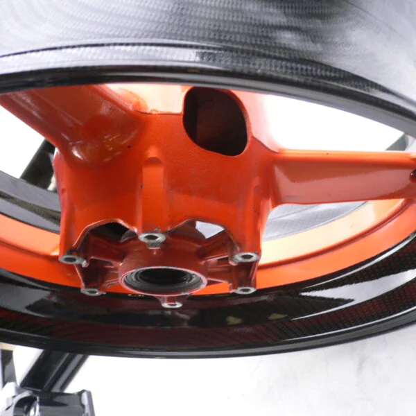 Motorbike alloy wheels coated in carbon fibre painted black and orange