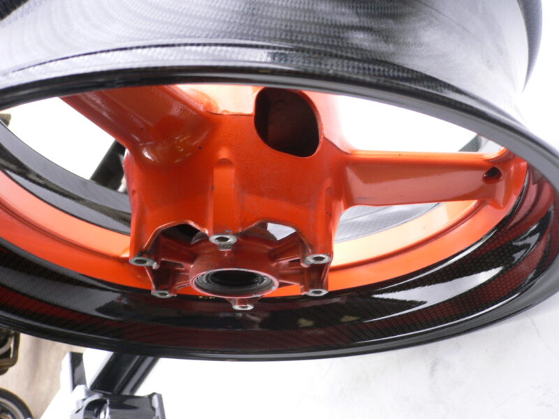 Motorbike alloy wheels coated in carbon fibre painted black and orange