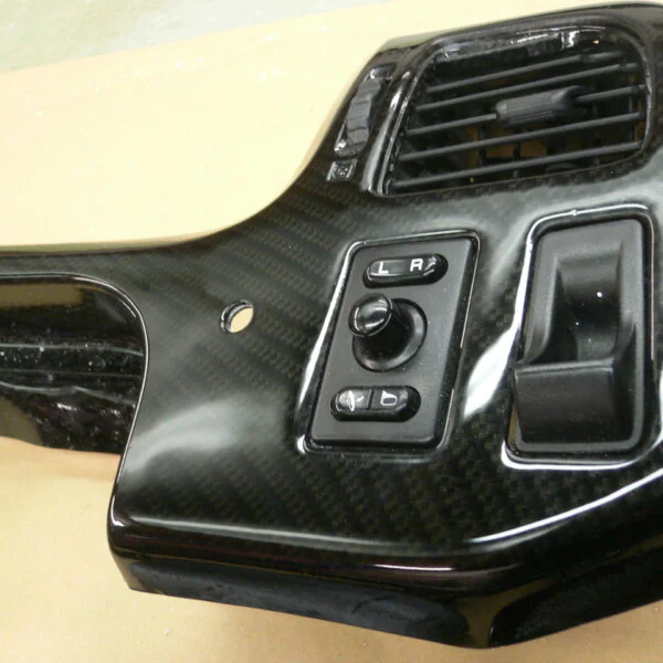 Parts of dashboard coated in carbon fibre