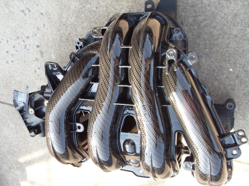 Car engine parts coated in carbon fibre