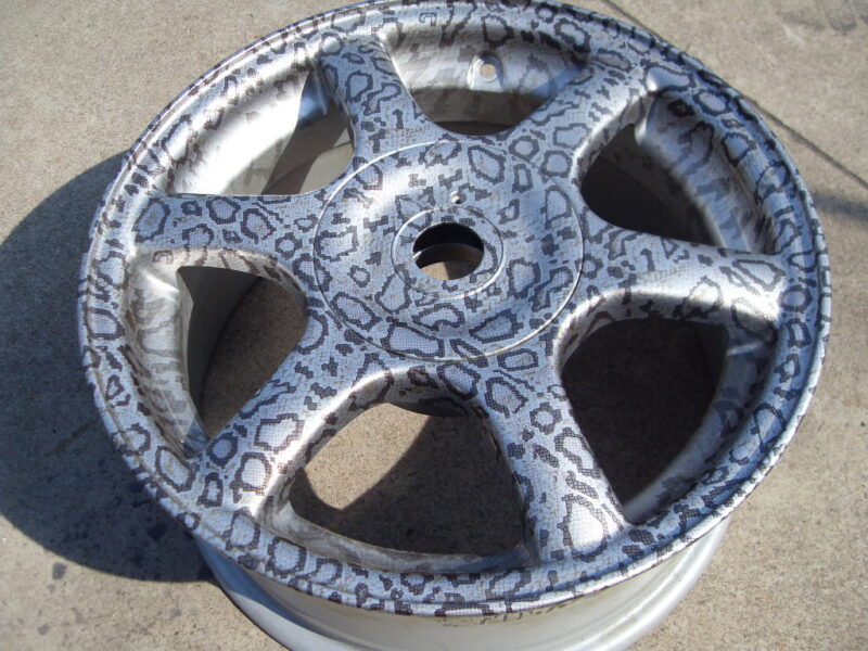 Car alloy wheels coated in panther hydrographic film