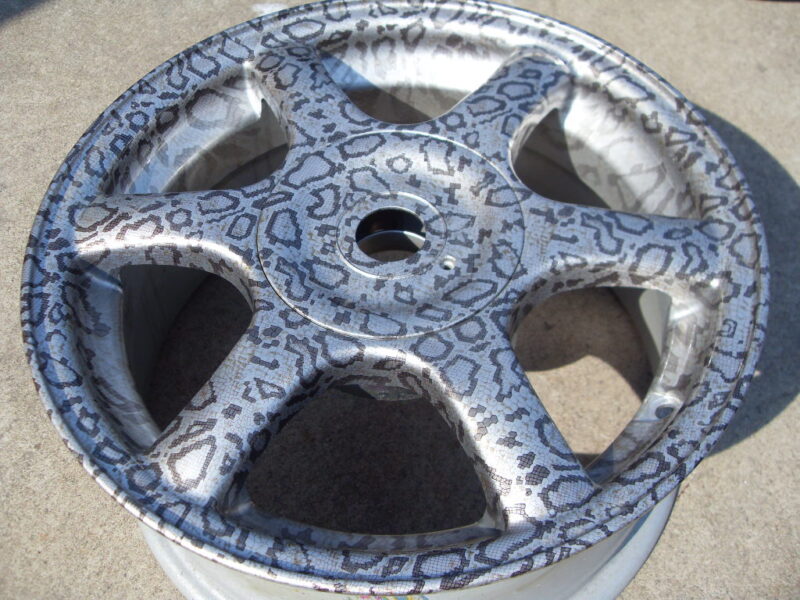 Car alloy wheels coated in panther hydrographic film