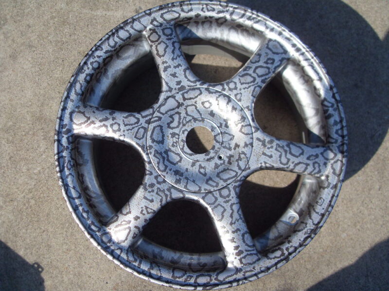 Car alloy wheels coated in panther hydrographic film