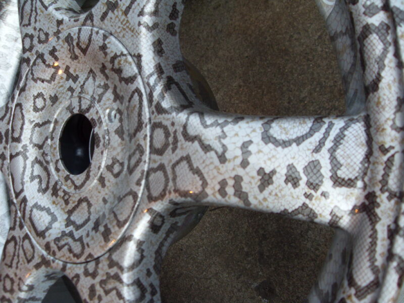 Car alloy wheels coated in panther hydrographic film