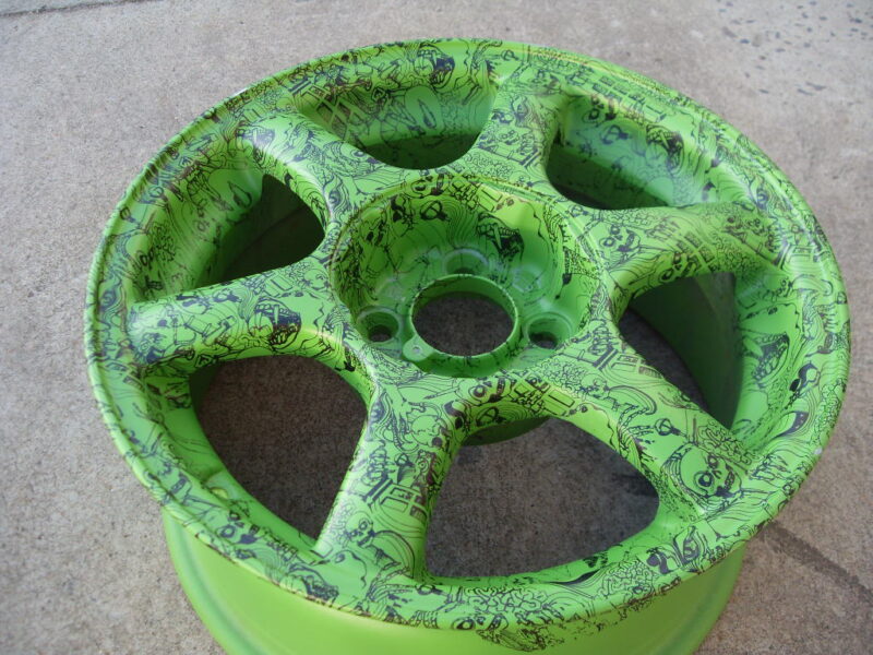 Car alloy wheels coated in skull painted green