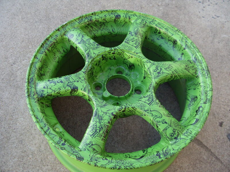 Car alloy wheels coated in skull painted green