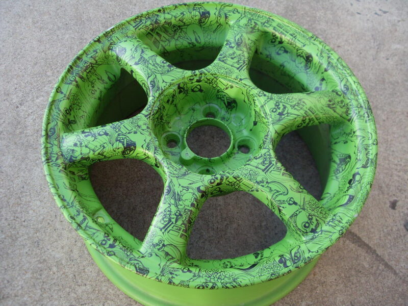 Car alloy wheels coated in skull painted green