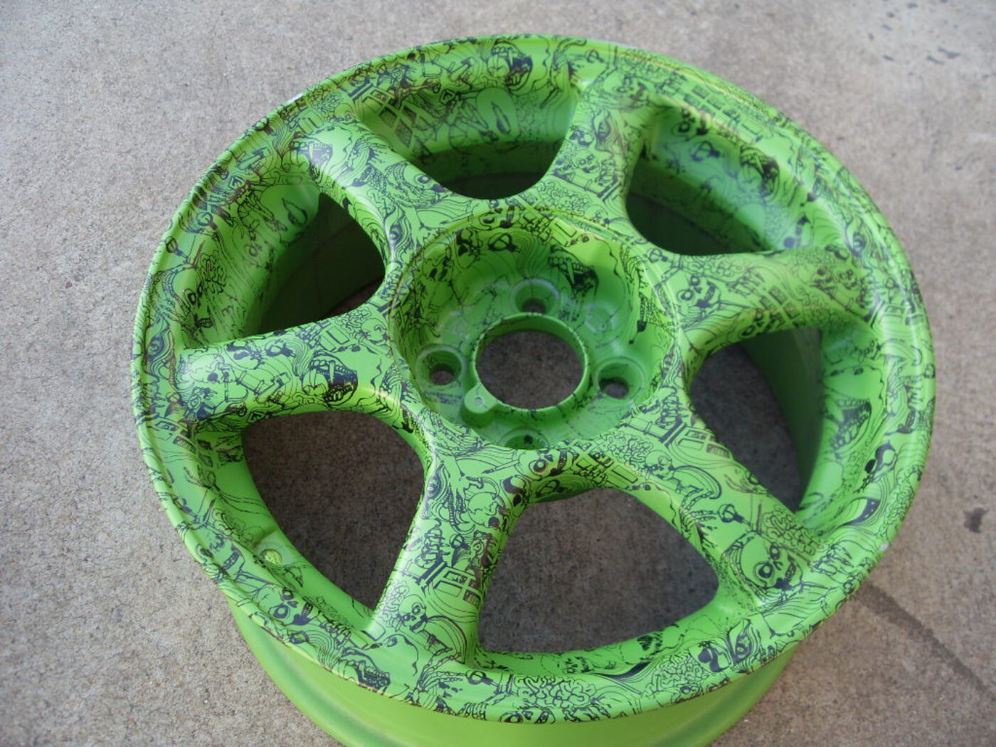 Car alloy wheels coated in skull painted green