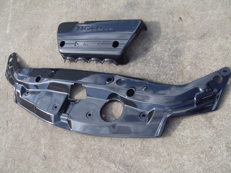 Honda engine cover coated in carbon fibre hydrographic film painted black