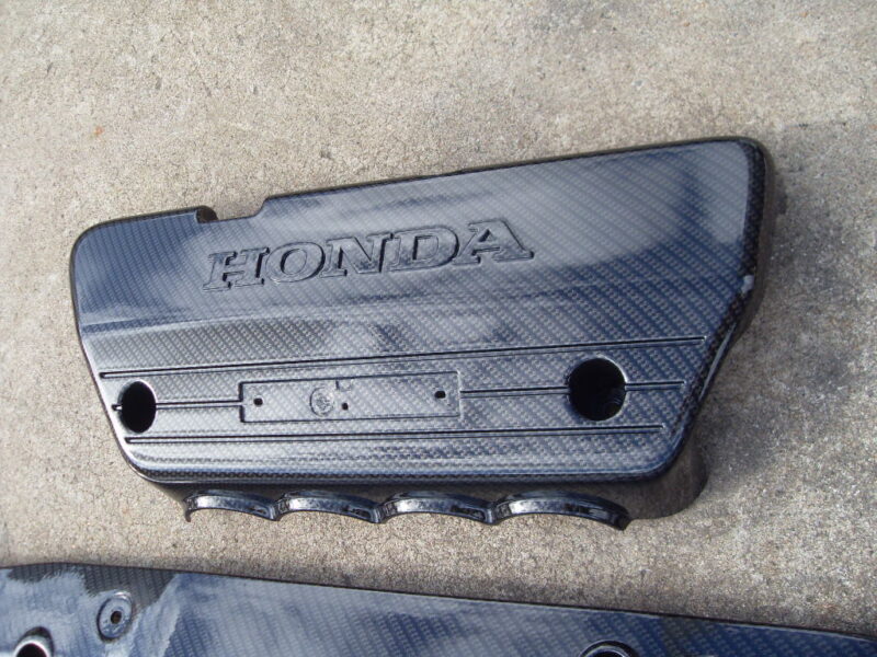 Honda engine cover coated in carbon fibre hydrographic film painted black