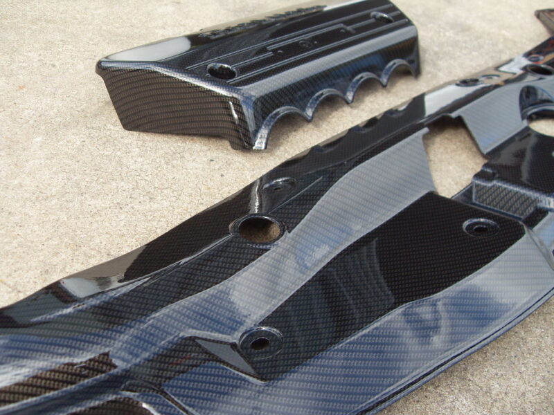 Honda engine cover coated in carbon fibre hydrographic film painted black