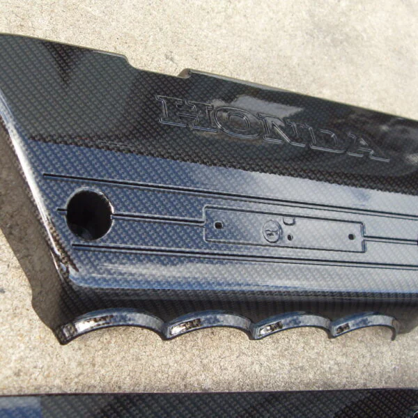 Honda engine cover coated in carbon fibre hydrographic film painted black