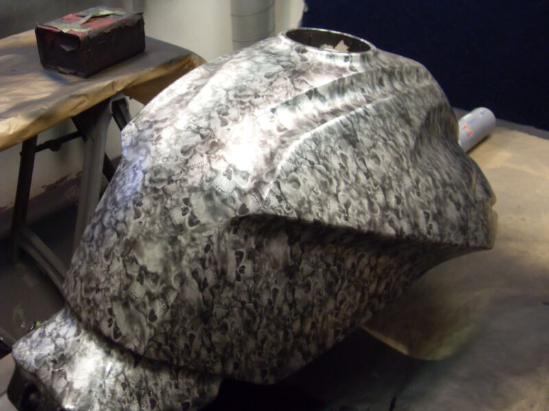 Motorbike tank coated in skull painted red