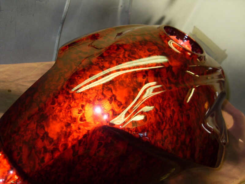 Motorbike tank coated in skull painted red