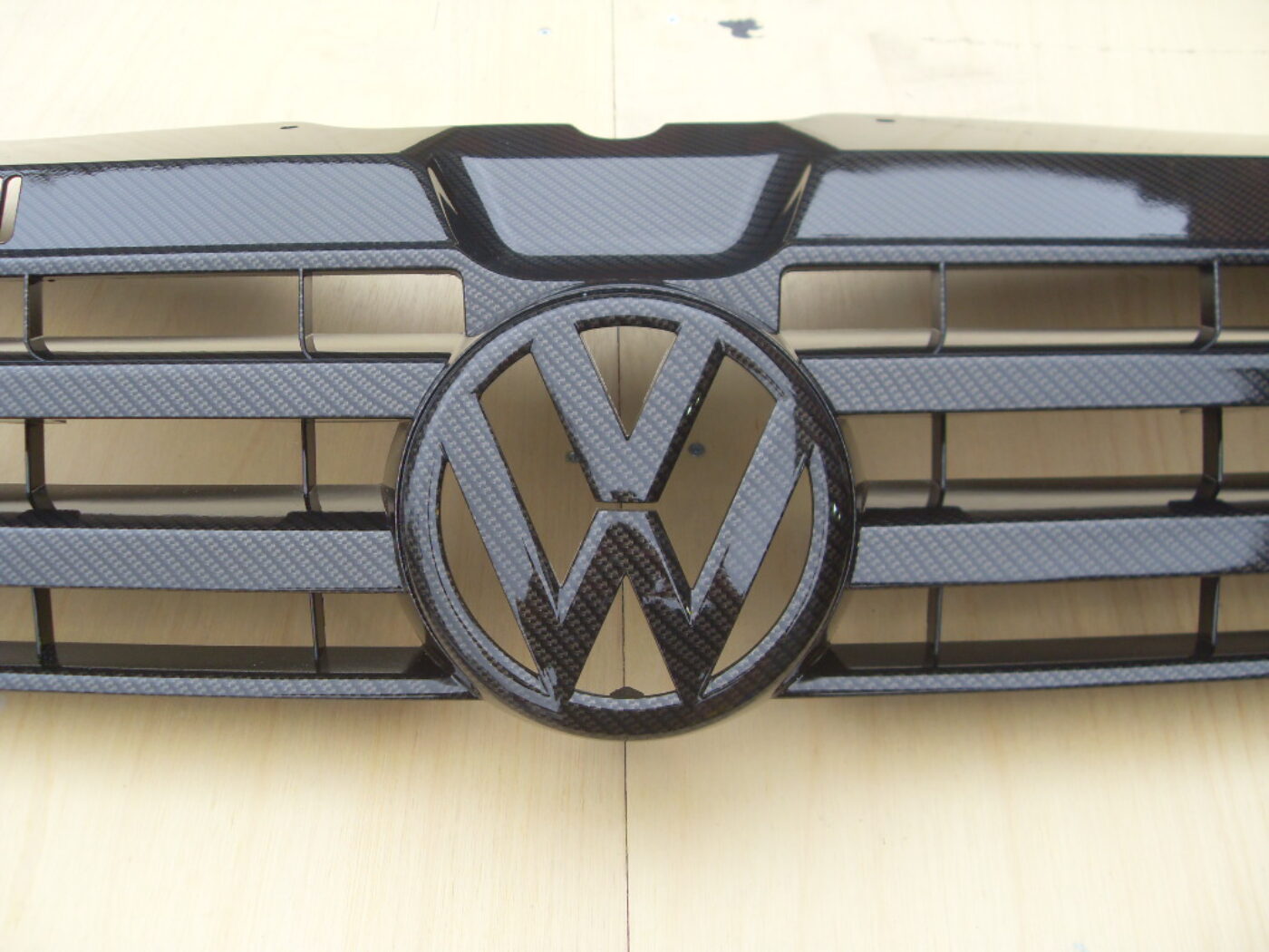 VW radiator cover coated in carbon fibre hydrographic film painted black