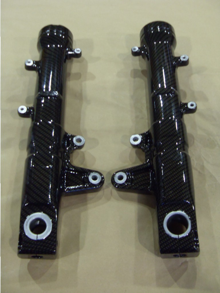 Motorbike parts coated in carbon fibre hydrographic film painted black
