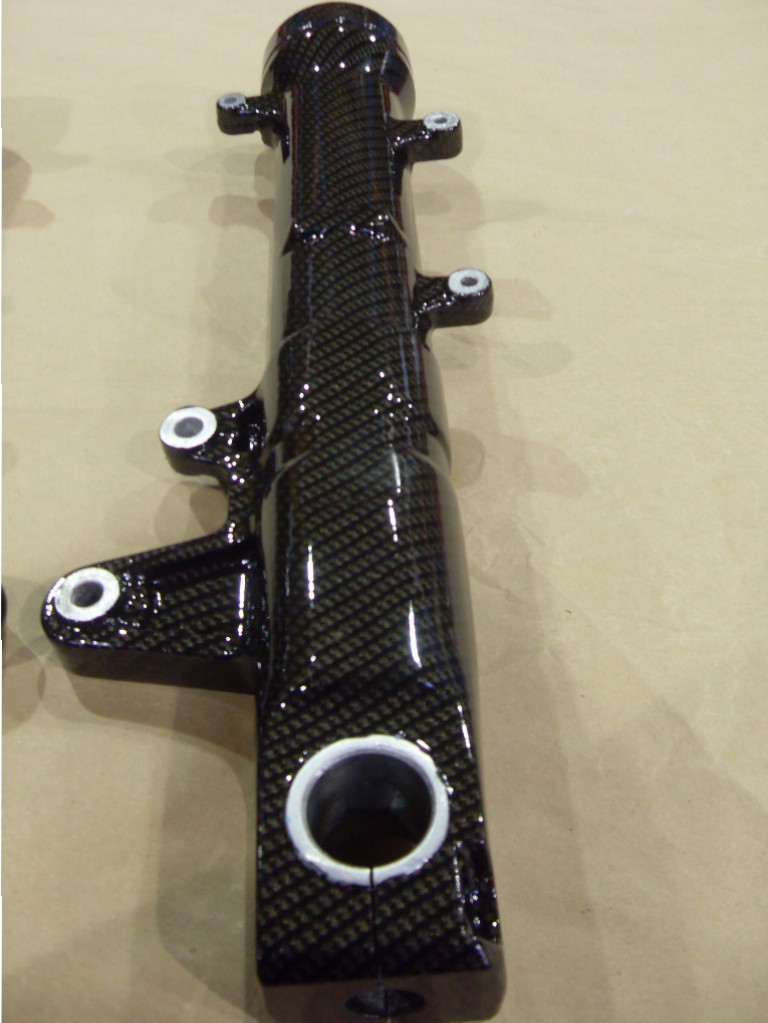 Motorbike parts coated in carbon fibre hydrographic film painted black