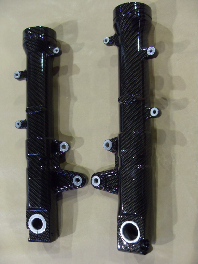Motorbike parts coated in carbon fibre hydrographic film painted black