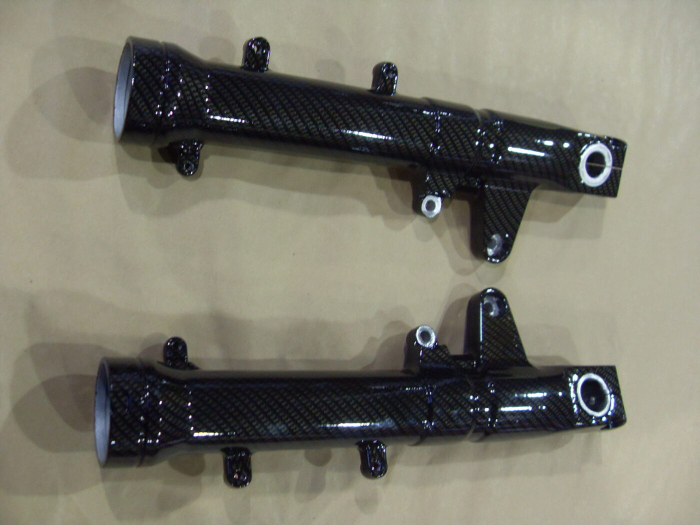 Motorbike parts coated in carbon fibre hydrographic film painted black