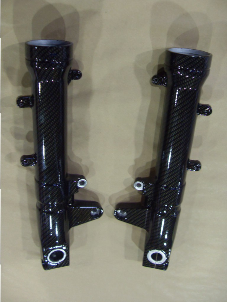 Motorbike parts coated in carbon fibre hydrographic film painted black