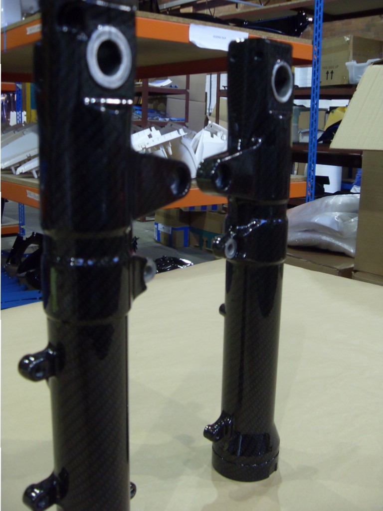 Motorbike parts coated in carbon fibre hydrographic film painted black