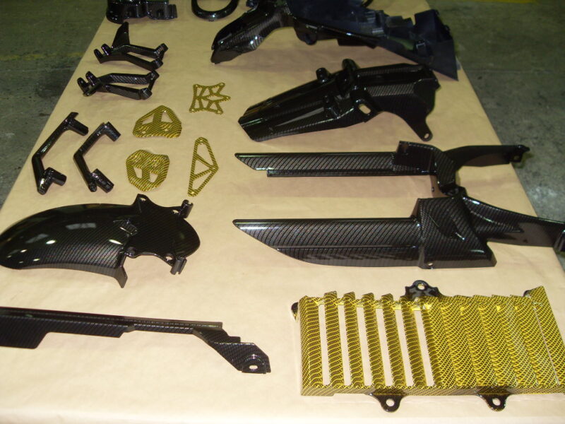 Motorbike various parts coated in carbon fibre hydrographic film painted black and yellow