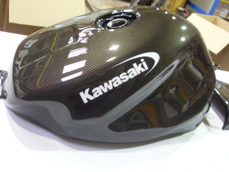 Motorbike tank coated in carbon fibre hydrographic film painted black