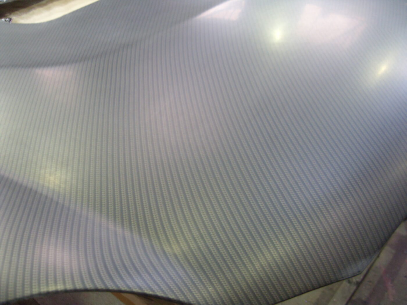 Car hood coated in carbon fibre painted silver