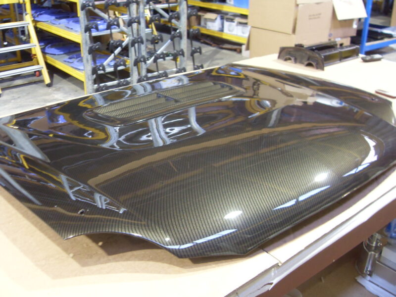Car hood coated in carbon fibre hydrographic film painted grey