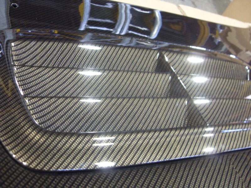 Car hood coated in carbon fibre hydrographic film painted grey