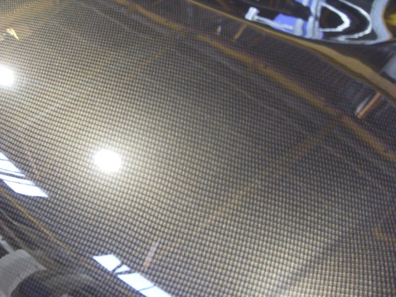 Car hood coated in carbon fibre hydrographic film painted grey