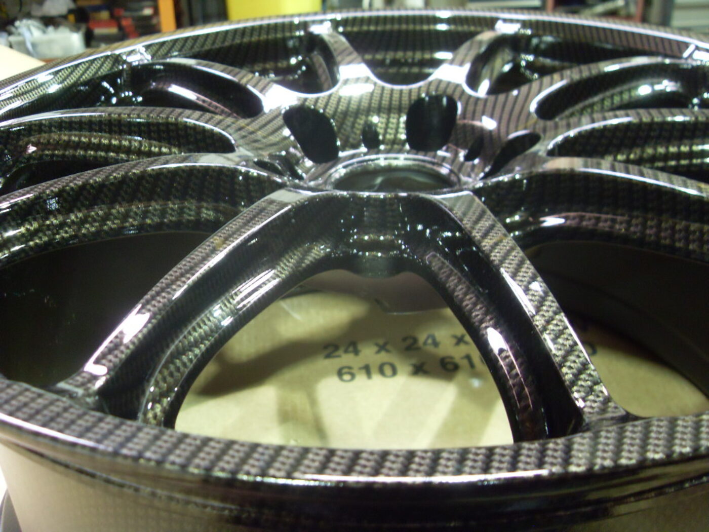 Car alloy wheels coated in carbon fibre painted black