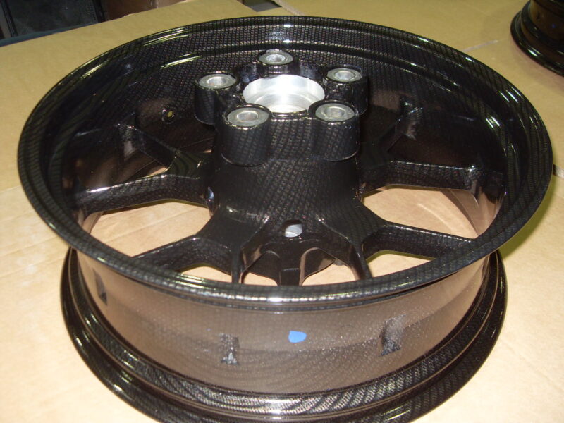 Motorbike alloy wheels coated in carbon fibre painted black